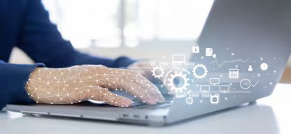 A person typing on a laptop with digital icons and network connections overlaying the hands